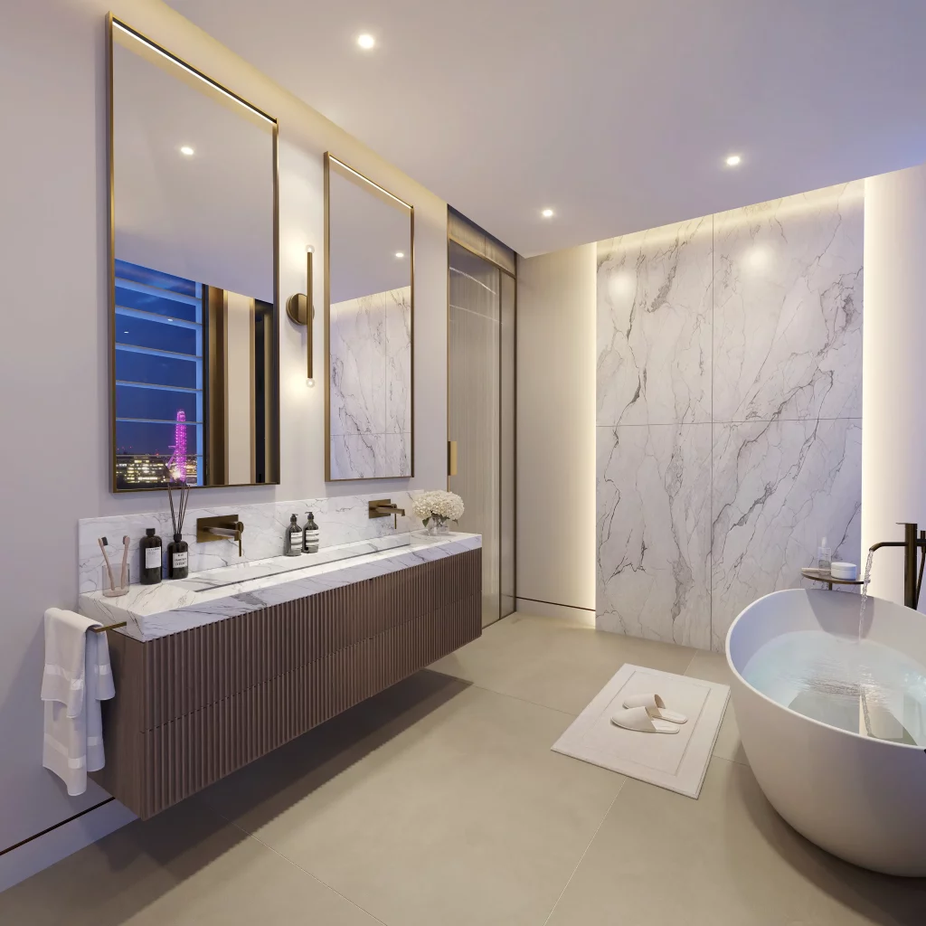 A luxurious bathroom is showcased, featuring a marble accent wall, a freestanding bathtub, and a modern vanity with dual mirrors. The space is illuminated by warm, recessed lighting, enhancing its serene and sophisticated ambiance.